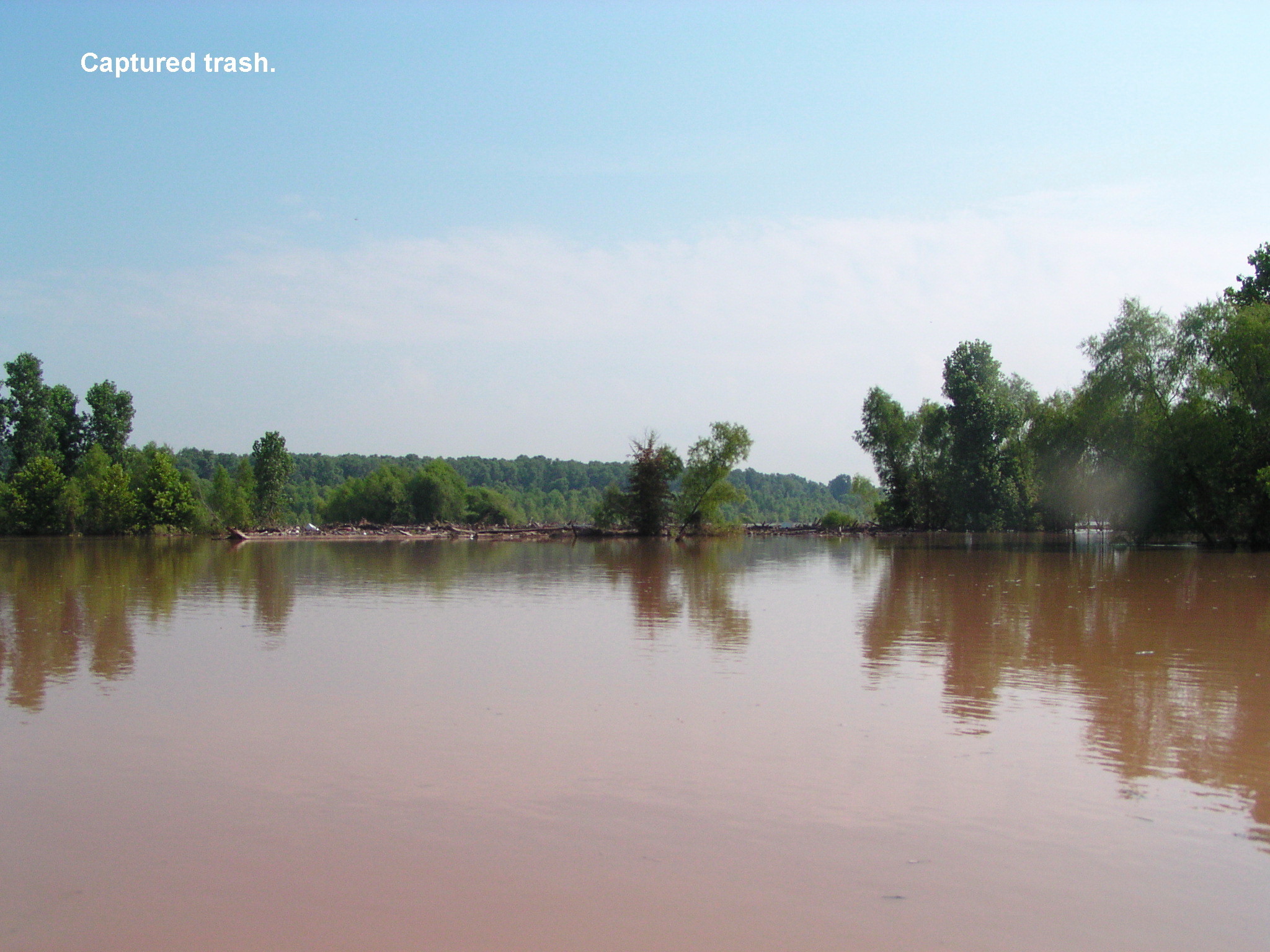 The river makes a bend around the trash at low water. At high water levels it crossed the bar where trash is snaged.